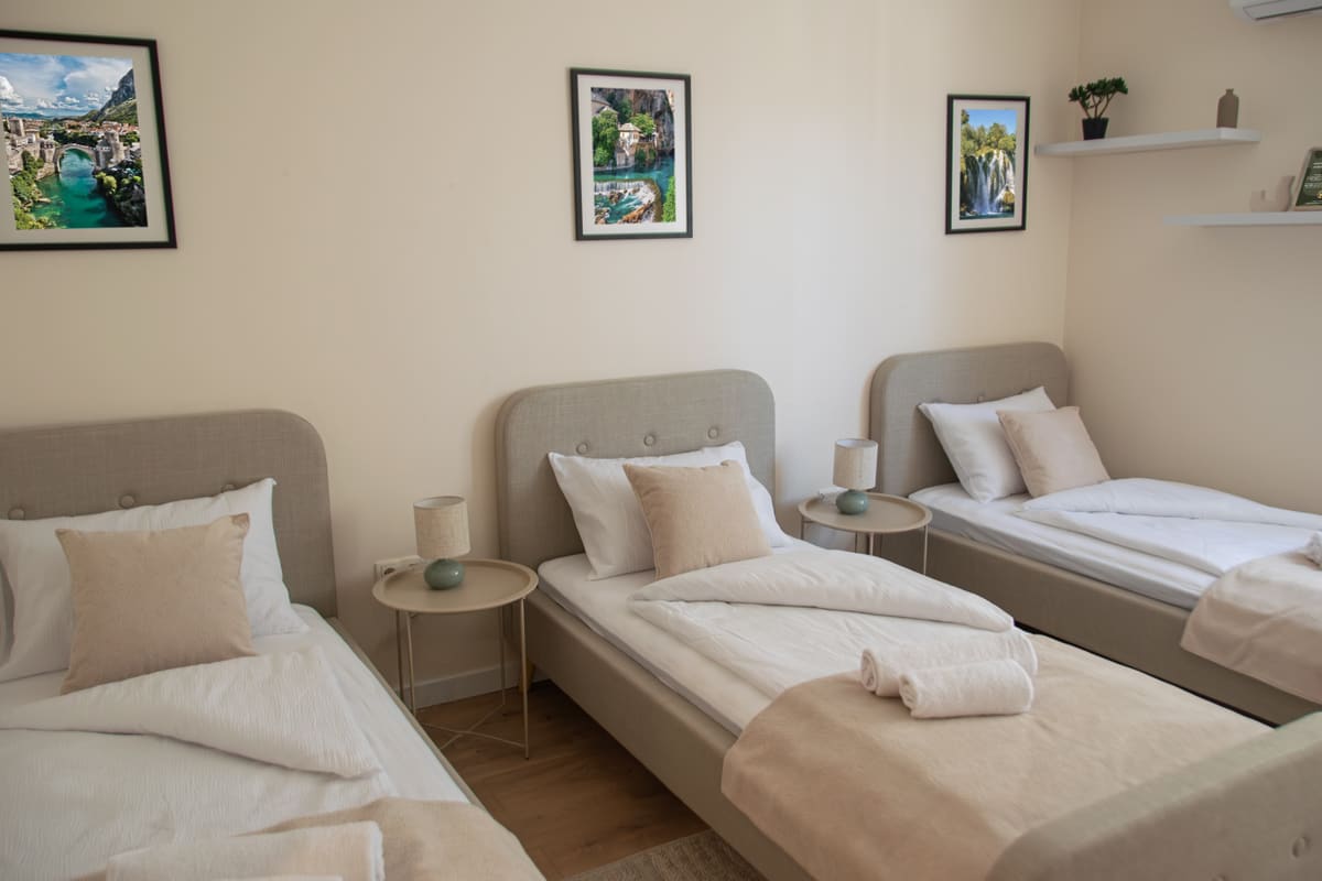 Cozy Room interior — Mediterranean king-size bed setup with warm olive tones